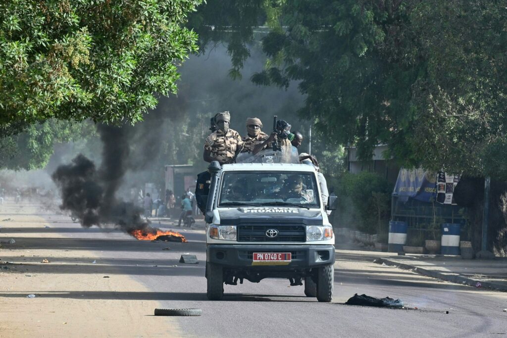 Chad policemen patrol in a vehicle during clashes with opposition demonstrators in N'Djamena on April 27, 2021. - At least five people were killed on April 27, 2021 during protests in Chad against a junta that took power after the death of longserving leader Idriss Deby Itno, prosecutors told AFP. (Photo by Issouf SANOGO / AFP) (Photo by ISSOUF SANOGO/AFP via Getty Images)